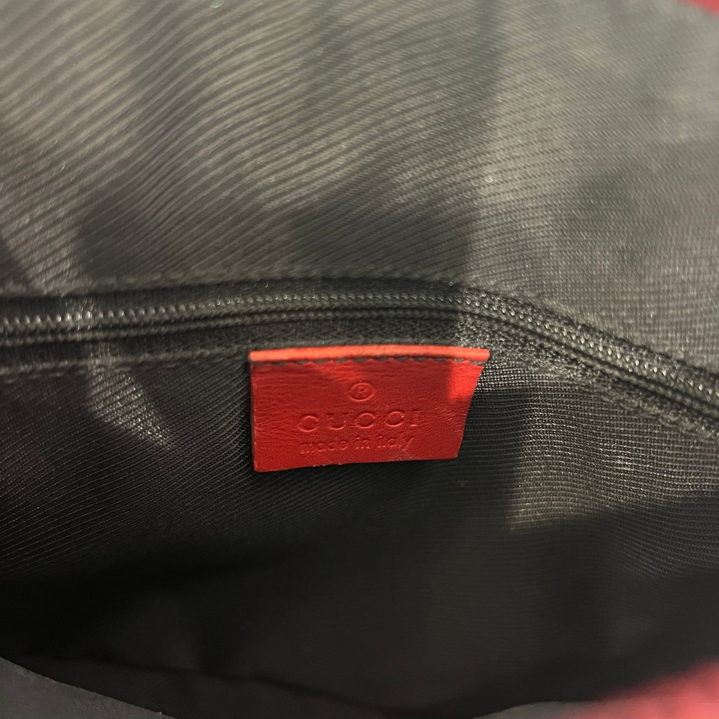 Gucci red monogram bag with red leather trimmings